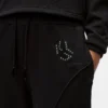 Pantalones de chándal con monograma y tachuelas Pantalones de chándal con monograma y tachuelas